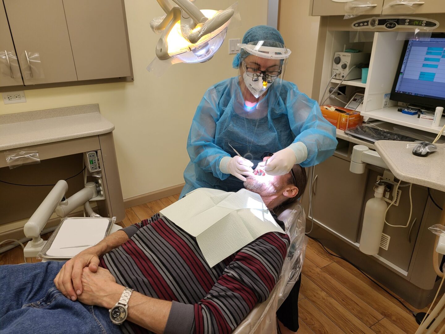 A Dentist Examining a Patient in Their Office