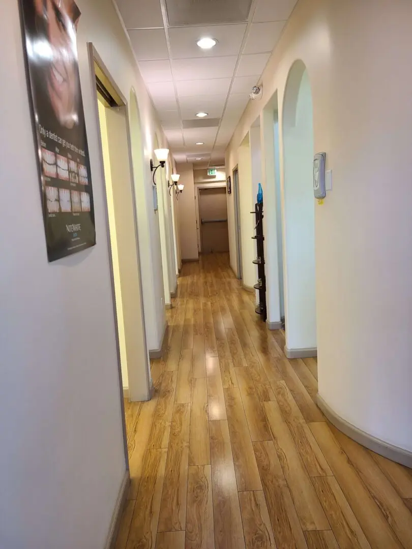 A Hallway With Panel Floor and White Walls
